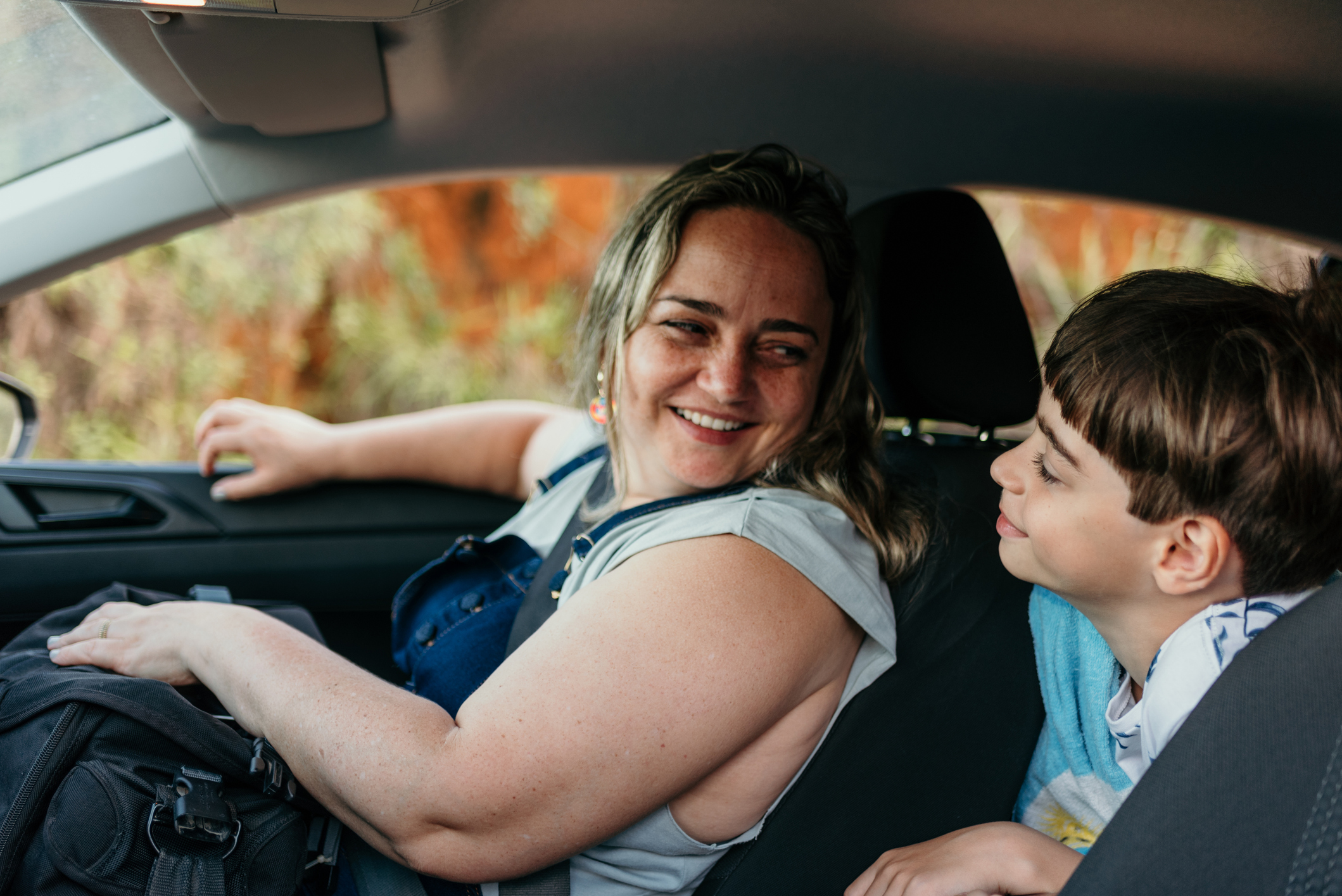 Mother and son in the passenger seat of the car