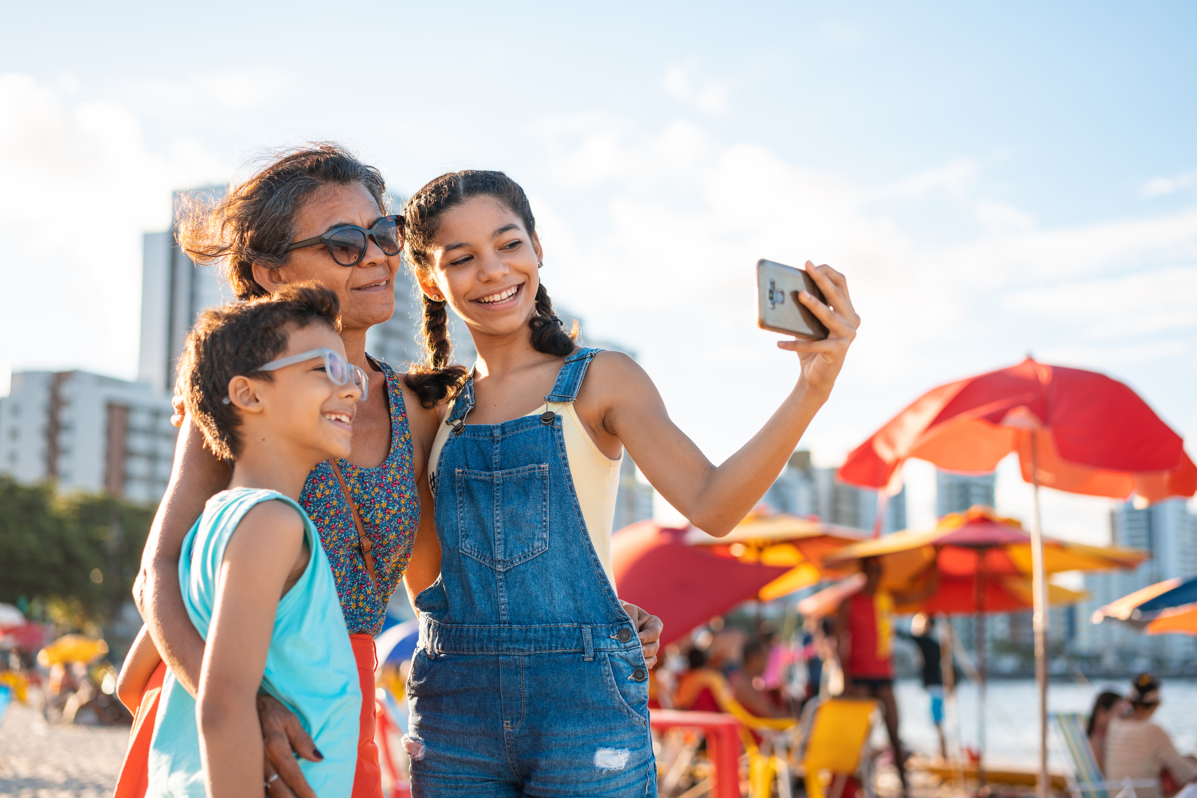 Family taking a selfie on the tropical beach in Pernambuco, Brazil